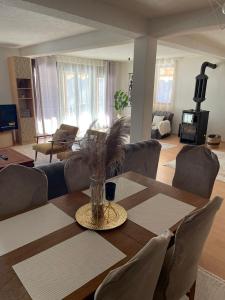 a living room with a wooden table and chairs at Mountain villa in Gorna Belica - Villa Hani in Struga