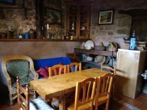 a dining room with a wooden table and chairs at Casa Lucia in Mogarraz