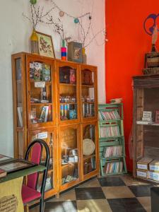 a wooden cabinet in a room with a book shelf at Hostel La Fortaleza in Bialet Massé
