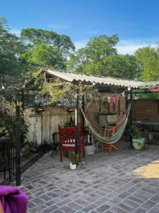 a patio with a hammock and a tent at Hostel La Fortaleza in Bialet Massé