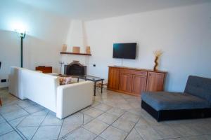 伊斯基亚Casa Don Peppino City Center的客厅配有沙发、椅子和电视