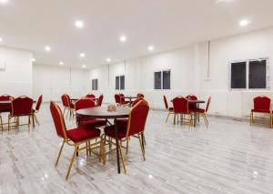 a conference room with tables and chairs in it at Super Capital O Che Sigma Hotel in Hyderabad +45 photos