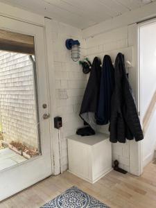 a room with a door and a wall at Wellfleet Vacation Townhome with Direct Marsh Views & Spa in Wellfleet +10 photos