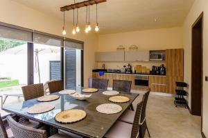 una sala da pranzo con tavolo e sedie di New! Gorgeous Tulum luxury villa with 2 pools a Tulum