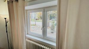 a window in a room with a radiator at Black and Ginger Residence in Zrenjanin