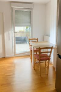 科尔贝埃索讷Omega Appartment的一间带桌椅的用餐室和滑动玻璃门