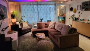 a living room with a couch and a table at Stylish Home within Central Wellington - Free Parking in Wellington