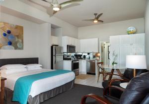 a bedroom with a bed and a table and a kitchen at Seashore On The Sand in Carlsbad