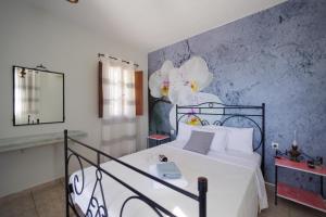 Un dormitorio con una cama blanca y una pared azul. en LITHOS by the sea, en Neon Oitilon 21 fotos más