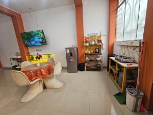 a room with a table and chairs and a refrigerator at Familiar 1er piso in La Merced