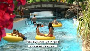 a group of people riding on tubes in the water at Apartalux Vera Rincón de Loix in Benidorm