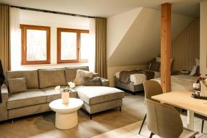 a living room with a couch and a bed at Spalter EINSER - Luxury Apartments & Ferienwohnungen in Spalt +107 photos