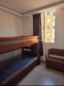 a room with two bunk beds and a window at Hermoso y acogedor apartamento en conjunto cerrado in Ibagué +2 photos