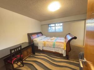 a bedroom with a bed and a desk and a window at Richmond 6011 in Richmond