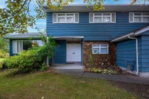 a blue house with a white door and a yard at Richmond 6011 in Richmond