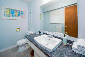 a bathroom with a sink and a toilet and a mirror at Richmond 6011 in Richmond