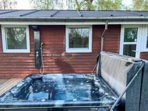 a hot tub in front of a house at 10 person holiday home in Juelsminde-By Traum in Juelsminde