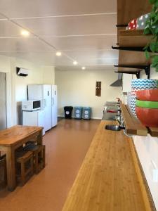 an empty room with a table and a refrigerator at Tailor Made Tekapo Accommodation - Hostel in Lake Tekapo
