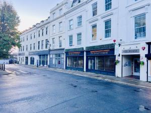 an empty street with a row of buildings at Fox House, Studio Apartments in Plymouth