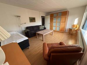 a living room with a couch and a table at The Coziest Farm Holiday In The Countryside in Tommerup
