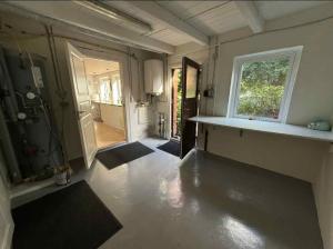 a room with a hallway with a door and a window at The Coziest Farm Holiday In The Countryside in Tommerup +12 photos