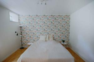 a bedroom with a bed and a wall at Stay In Hindemaes Historic Managers House in Ullerslev +6 photos