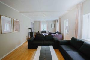 a living room with a couch and a table at Stay In Hindemaes Historic Managers House in Ullerslev
