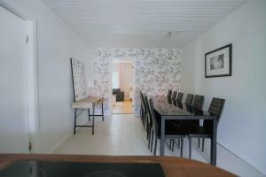 a dining room with a table and chairs at Stay In Hindemaes Historic Managers House in Ullerslev