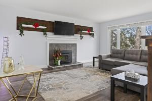 a living room with a couch and a fireplace at Abby's Place in Fredericton