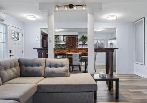 a living room with a couch and a table at Cozy 3BR Downtown Fredericton Home with Parking in Fredericton