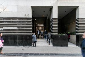 a group of people standing outside of a building at Moderno Apartamento a pasos del Metro y Museo Bellas Artes, Cerro Santa Lucia, Barrio Lastarria in Santiago