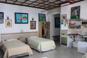 a hospital room with two beds and a counter at Aparthotel Maison Suisse in Asunción