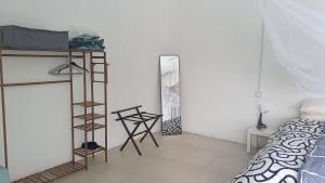 a bedroom with a bed and a ladder and a mirror at Les zoliviers in Petite Rivière