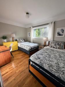 a bedroom with two beds and a window at Mid-Century Modern Apartment at Horner Park in Victoria