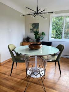 a dining room with a table and chairs at Mid-Century Modern Apartment at Horner Park in Victoria