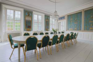 a large dining room with a table and chairs at Hindemae Estate For Holidays And Events in Ullerslev