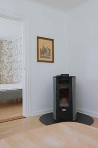 a room with a stove in the corner of a room at Bright Modern Holiday Home Near Hindemae in Ullerslev