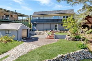 an exterior view of a house with a yard at Luna Beach House, Vincentia in Vincentia