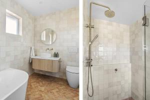 a bathroom with a shower and a sink and a toilet at Luna Beach House, Vincentia in Vincentia +14 photos