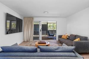 a living room with a couch and a table at Luna Beach House, Vincentia in Vincentia