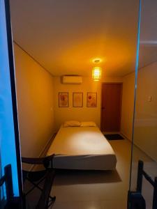 a bedroom with a bed in a room at Enseada Beach in São Sebastião