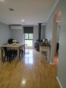 a kitchen and dining room with a table and chairs at 4 Westcott Parade Rockbank in Rockbank +4 photos
