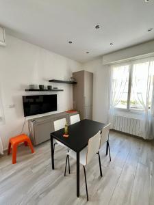 a kitchen and dining room with a table and chairs at La vista Azzurra in Bordighera