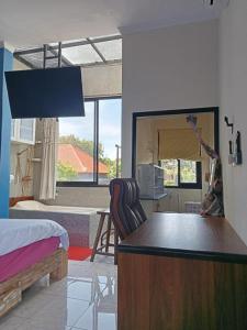 Una cama o camas en una habitación de Ceria House Ungasan Uluwatu