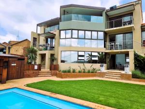 a house with a swimming pool in front of it at Weston Guest House Krugersdorp in Krugersdorp