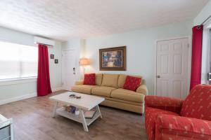 a living room with a couch and a table at 1BR Cocoa Beach Home - 1 Min to Beach in Cape Canaveral