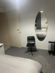 a room with a chair and a mirror at Bridgewater Court 2 in Southampton