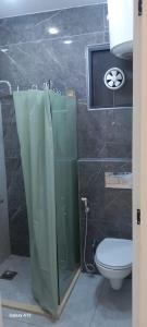 a bathroom with a shower and a toilet at غزو 15 in Aydūn