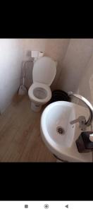 Un baño con un inodoro blanco y un lavabo. en Guests House With View Rooftop, en Marrakech