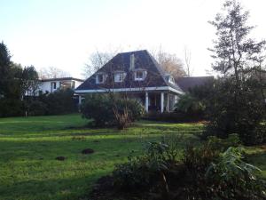 汉堡Holiday home in beautiful Hamburg的一栋坐落在绿树成荫的院子里的房子